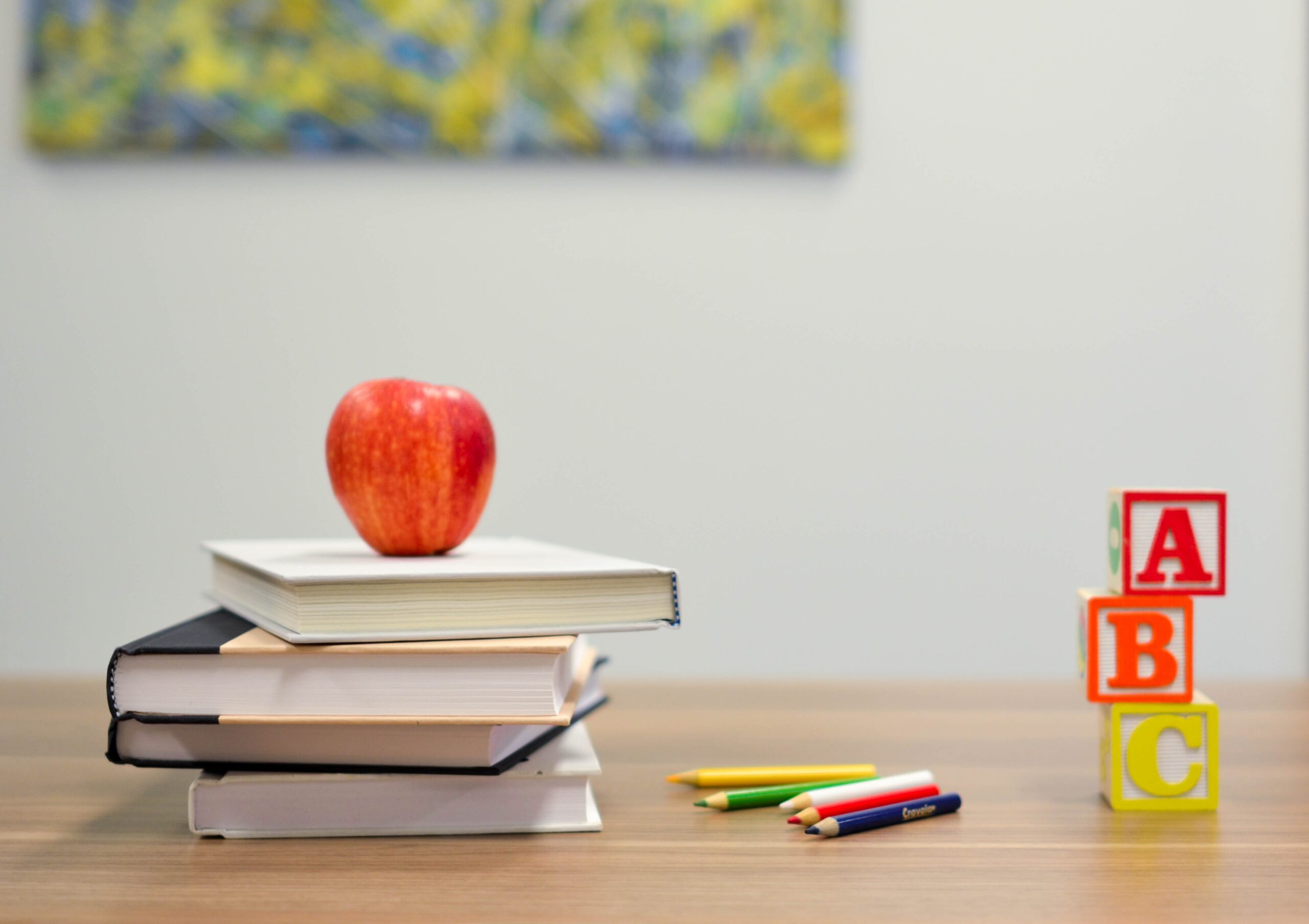 a stack of books with an apple on them